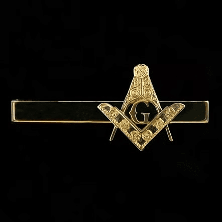 Display case featuring Masonic pins, Masonic cross, and Masonic medals for lodge use.