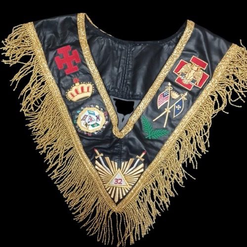 Masonic cross engraved on a lapel pin, part of formal Masonic clothing and accessories. Masonic earrings with symbolic designs, displayed alongside pines masons and medals. Display case featuring Masonic pins, Masonic cross, and Masonic medals for lodge use. Traditional Masonic clothing and attire with embroidered Masonic star and symbolic pins. Masonic cross and star featured on jewelry pieces like medals masons and pendants. Set of Masonic earrings, medals, and pins complementing formal lodge attire. Masonic pins with engraved symbols, arranged beside ceremonial Masonic clothing and medals.